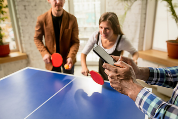 Image showing Young people playing table tennis in workplace, having fun