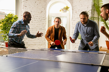 Image showing Young people playing table tennis in workplace, having fun