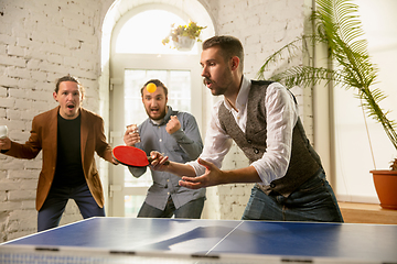 Image showing Young people playing table tennis in workplace, having fun