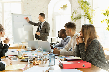 Image showing Group of young business professionals having a meeting, creative office