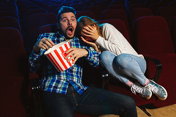 Image showing Attractive young caucasian couple watching a film at a movie theater