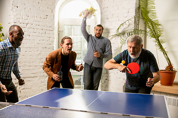 Image showing Young people playing table tennis in workplace, having fun