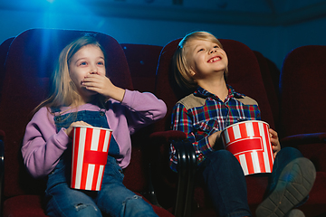 Image showing Little girl and boy watching a film at a movie theater