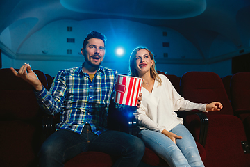 Image showing Attractive young caucasian couple watching a film at a movie theater