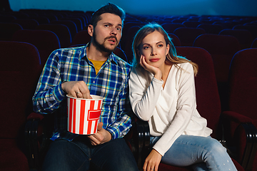 Image showing Attractive young caucasian couple watching a film at a movie theater