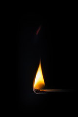 Image showing match stick flame in front of a black background