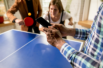 Image showing Young people playing table tennis in workplace, having fun