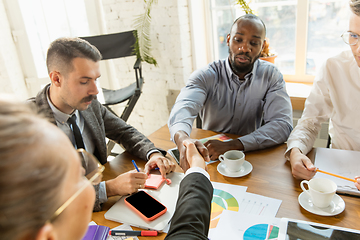 Image showing Group of young business professionals having a meeting, creative office