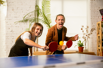 Image showing Young people playing table tennis in workplace, having fun