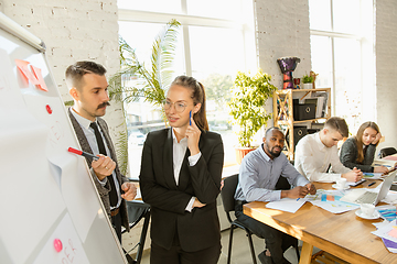 Image showing Group of young business professionals having a meeting, creative office