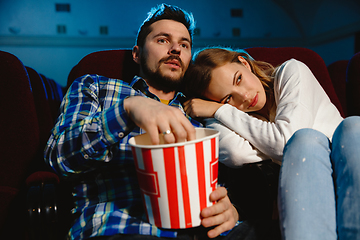 Image showing Attractive young caucasian couple watching a film at a movie theater