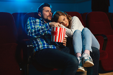 Image showing Attractive young caucasian couple watching a film at a movie theater