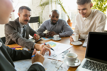 Image showing Group of young business professionals having a meeting, creative office