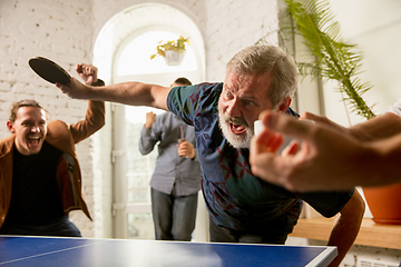 Image showing Young people playing table tennis in workplace, having fun