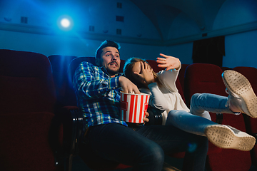 Image showing Attractive young caucasian couple watching a film at a movie theater