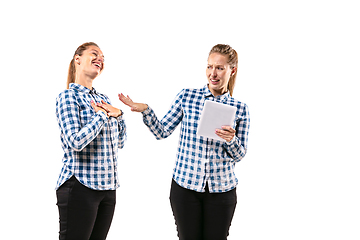 Image showing Young handsome woman arguing with herself on white studio background.