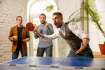 Image showing Young people playing table tennis in workplace, having fun