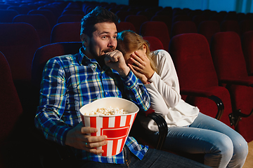 Image showing Attractive young caucasian couple watching a film at a movie theater