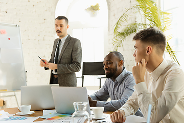 Image showing Group of young business professionals having a meeting, creative office