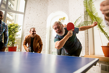 Image showing Young people playing table tennis in workplace, having fun