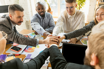 Image showing Group of young business professionals having a meeting, creative office