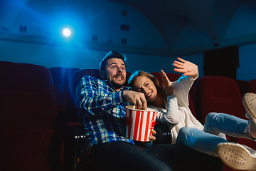 Image showing Attractive young caucasian couple watching a film at a movie theater