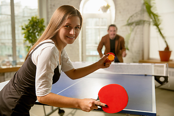 Image showing Young people playing table tennis in workplace, having fun