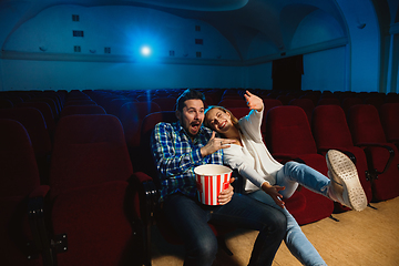 Image showing Attractive young caucasian couple watching a film at a movie theater