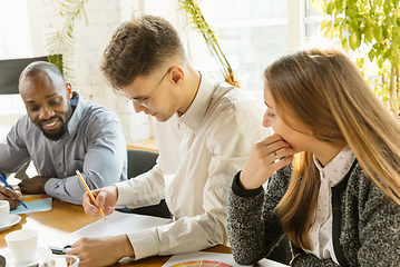 Image showing Group of young business professionals having a meeting, creative office