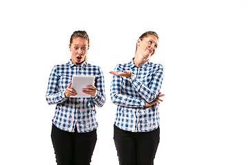 Image showing Young handsome woman arguing with herself on white studio background.