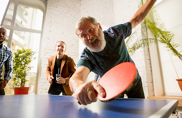 Image showing Young people playing table tennis in workplace, having fun