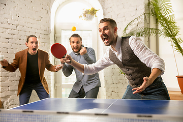 Image showing Young people playing table tennis in workplace, having fun