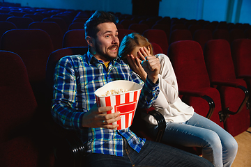 Image showing Attractive young caucasian couple watching a film at a movie theater