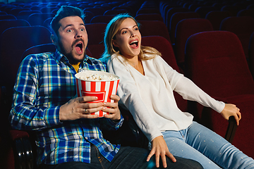 Image showing Attractive young caucasian couple watching a film at a movie theater