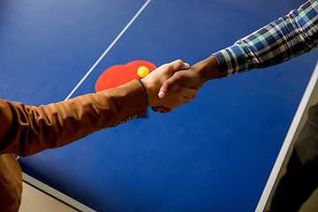 Image showing Young men playing table tennis in workplace, having fun