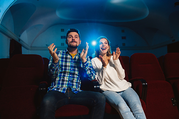 Image showing Attractive young caucasian couple watching a film at a movie theater