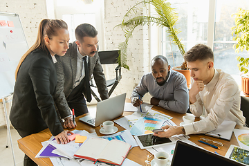 Image showing Group of young business professionals having a meeting, creative office