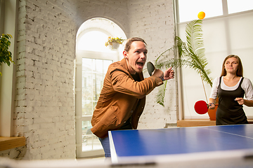 Image showing Young people playing table tennis in workplace, having fun