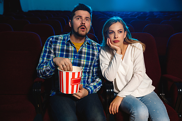 Image showing Attractive young caucasian couple watching a film at a movie theater