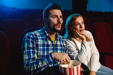 Image showing Attractive young caucasian couple watching a film at a movie theater