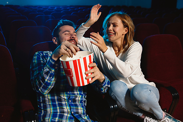 Image showing Attractive young caucasian couple watching a film at a movie theater