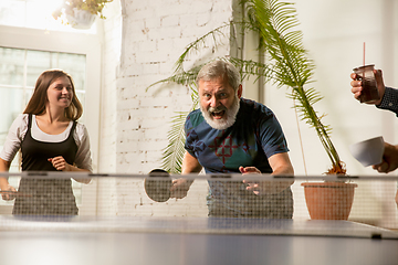 Image showing Young people playing table tennis in workplace, having fun