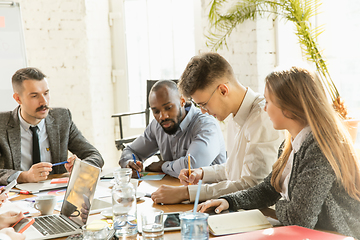 Image showing Group of young business professionals having a meeting, creative office