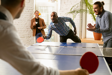 Image showing Young people playing table tennis in workplace, having fun