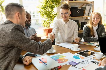 Image showing Group of young business professionals having a meeting, creative office