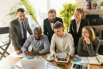 Image showing Group of young business professionals having a meeting, creative office