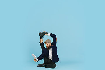 Image showing Businessman having fun dancing break dance on blue background at work