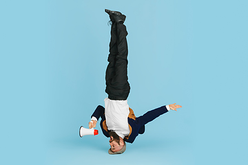 Image showing Businessman having fun dancing break dance on blue background at work