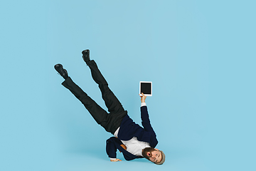 Image showing Businessman having fun dancing break dance on blue background at work