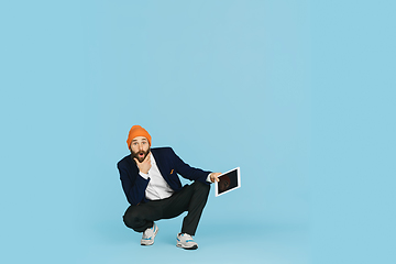 Image showing Businessman having fun dancing break dance on blue background at work